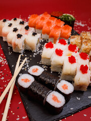 delicious set of rolls featuring fresh maki with salmon and tasty Philadelphia cheese, with shrimp and salmon, along with a delightful baked roll and two appetizing rolls with red and black caviar 
