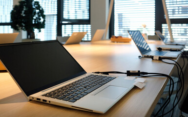 Laptop on a table in a co-working space