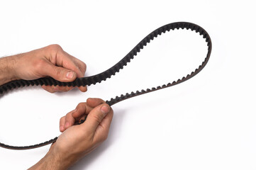 timing belt in the hands of an auto mechanic. isolated on white