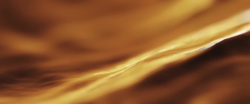Silky smooth golden caramel waves flowing and rolling by in a slow motion looped time lapse. 4k ultrawide 2:39:1 cinemascope aspect ratio, shallow depth of field lens blur. 
