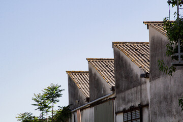 Fototapeta premium Industrial Warehouse Roofs with Blue Sky Background
