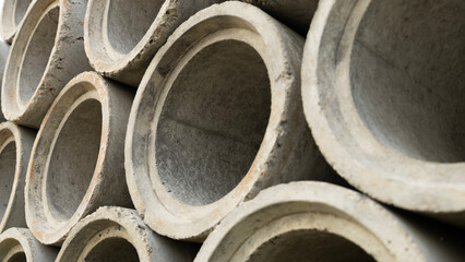 Round cement pipes are used for drainage pipes in buildings. Concrete pipes as a background for graphic design work.