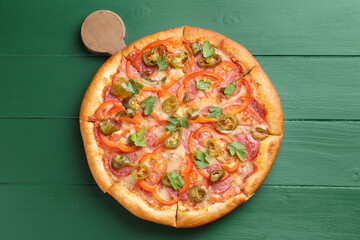 Delicious pizza Diablo on green wooden table, top view