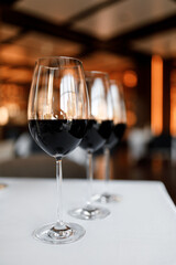 Red wine in a glass on a beautiful white tablecloth in a nice restaurant