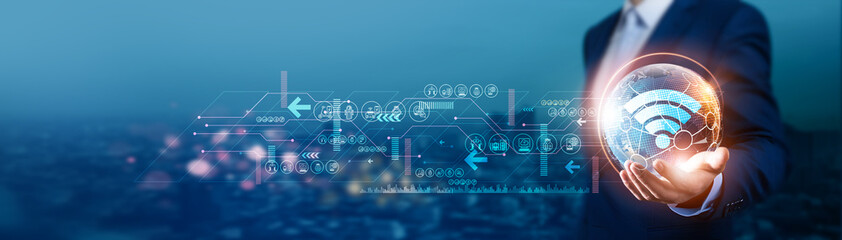 IOT. Businessman holds global Internet of Things (IoT) with network connected to smart devices, cloud services, and advanced analytics. Technological development contributes to enhanced connectivity.