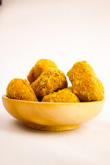 Tahu goreng cripsy, or crispy fried tofu, is one type of snack in Indonesia on wood plate isolated on white background. Perfect for recipe, article, catalogue, commercial, or any cooking contents
