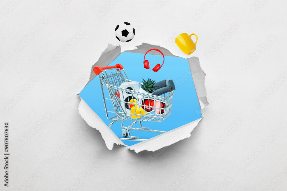 Poster Ragged hole in paper with a shopping cart full of products emerging. Concept of shopping and buying various items through a creative perspectiv