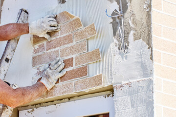 DIY Facade Finish With Imitation Brick, homeowner adding panel with false brick on facade.