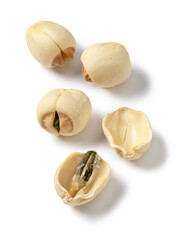 Whole and halved dried Lotus seed isolated on white background close up