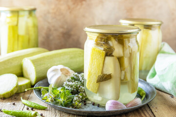 Healthy homemade fermented food. Pickled zucchini with mint preserved canned in glass jar. Home...