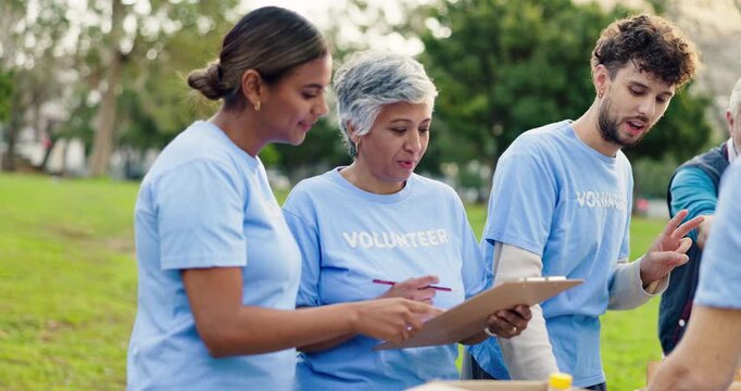 Clipboard, nature and group of volunteers with donations for community work at event at outdoor park. Charity, people and ngo team with food boxes or package for distribution in field with checklist.