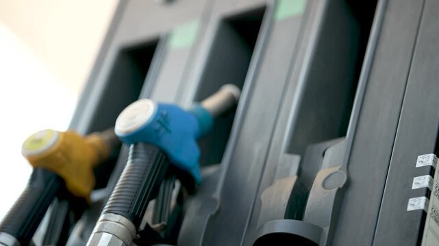 Refueling a Car at Gas Station with a fuel pump for oil or gasoline to fill up