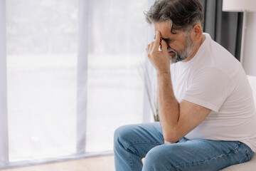 Home, senior man and headache on sofa for stress, emotional conflict and temporal vertigo. Living...