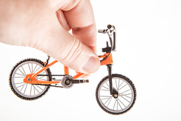 Naklejka premium image of miniature bicycle hand white background 