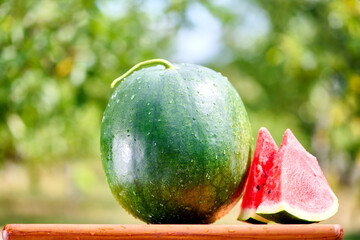 Slices of fresh watermelon on the rustic wooden table