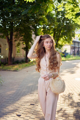 a beautiful teenage girl in a peach fuzz suit with a waistcoat, in the old money style  walks...
