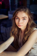 a  beautiful teenage girl in a peach fuzz suit with a vest, in the old money style in a fancy...