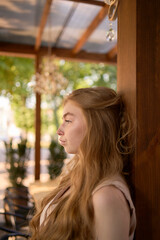 a  beautiful teenage girl in a peach fuzz suit with a vest, in the old money style in a fancy...