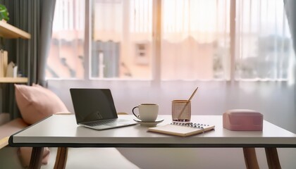 マグカップとパソコンの置かれたかわいいデスク