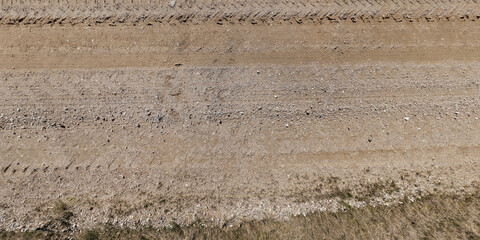 view from above on texture gravel road with median with lawn