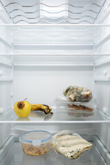 Moldy meal wrapped in cling film in the refrigerator. Incorrect storage, spoiled product, expired...