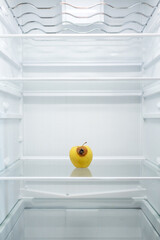 Moldy spoiled apple in the refrigerator. Improper storage, spoiled product, expired concept. Part of a series