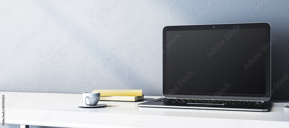 Poster modern laptop with blank screen on desk with cup and books. 3d rendering