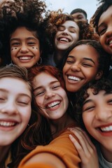 Obraz premium A group of young women are smiling and hugging each other. Concept of happiness and camaraderie among the group