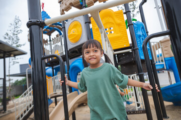 Fototapeta premium Each moment at the playground is an adventure, and she treasures every second.