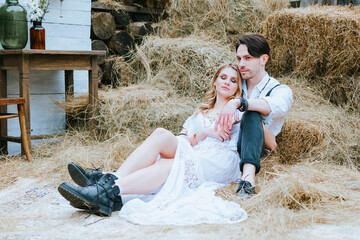 wedding boho style ceremony young couple newlyweds bride in white dress with veil and groom in hat...