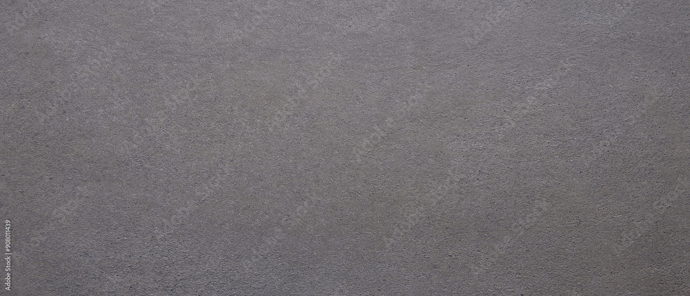 Aufkleber a grey surface with a few small holes. the surface is not very smooth as background.
