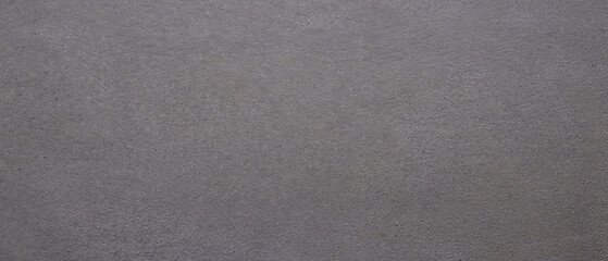 A grey surface with a few small holes. The surface is not very smooth as background.