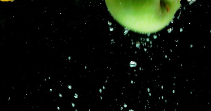 Lemon, water and citrus fruit with vitamin c for fresh produce, hydration or wash on a black background. Closeup of natural organic food, nutrition or citric acid in splash for healthy diet or fiber
