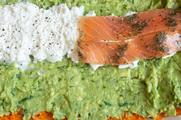 A close-up view of a delicious and healthy dish featuring smoked salmon, fresh ricotta cheese, and creamy guacamole. The vibrant colors and textures create an appetizing presentation. Healthy food.