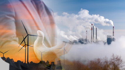 Double exposure of businessman with silhouette of wind turbine and Industrial factory plant with...