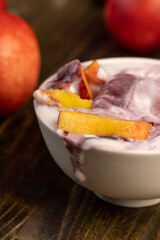 natural yogurt in a white bowl with fruits