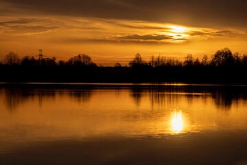 reflection of trees at sunset, river with reflection