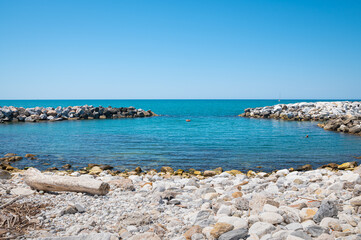 Rocky beach with the beautiful blue ¨Ligurian Sea¨ in Marina di Pisa, Italy