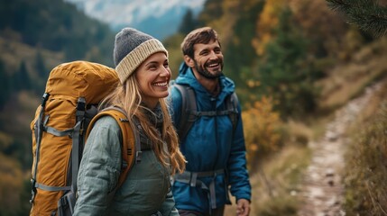 Fototapeta premium Couple smiling and holding hands on a mountain trail