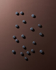 Blueberries on brown background with shadows