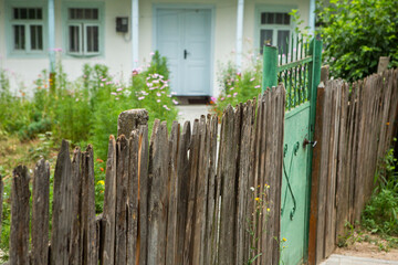 Naklejka premium Old traditional wooden house with painted door, narrow wooden windows in the country.