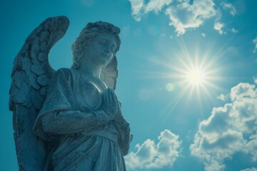 White statue of angel praying with sunlight background