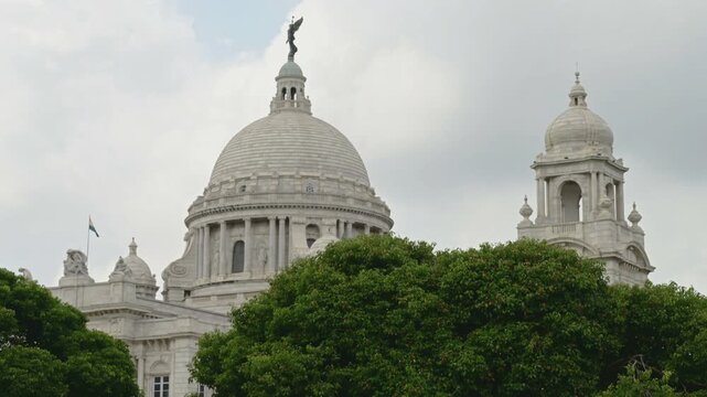 Victoria Memorial, large marble monument on the Maidan in Central Kolkata, West Bengal, India. Time lapse 4K video with monsoon sky and clouds passing over the architecture.
