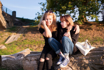 Communication of a mother and a teenage daughter, a teenage girl emotionally tells her mother about...