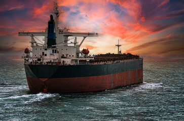 Cargo ship in aerial view under beautiful cloudy sky