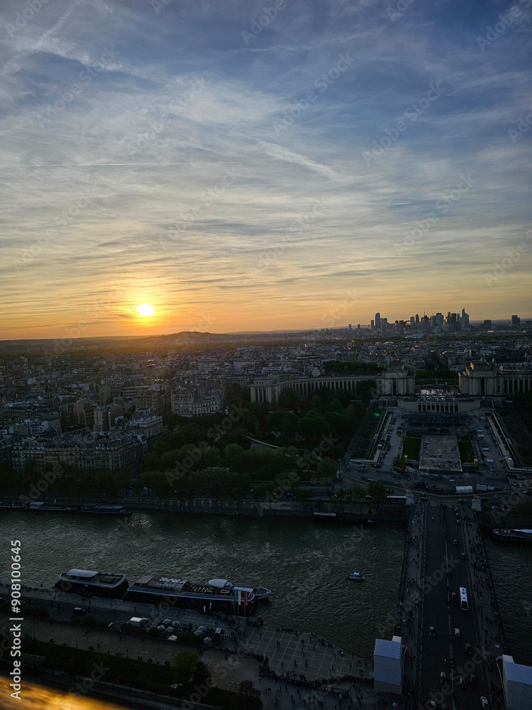 Wall mural paris, france - april 12, 2024: aerial view to the city of paris, during the golden hour between mod