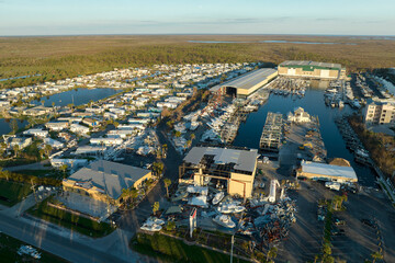 Warehouse with motorboats and yachts destroyed by hurricane winds in Florida coastal area. Natural disaster and its consequences