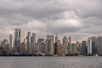 New York, NY, USA - August 4, 2023: Mid Manhattan skyline under gray menacing cloudscape, seen from...
