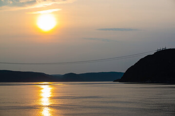 Fototapeta premium Tadoussac, Canada - July 28 2024: Stunning sunset sight in Saguenay fjord 