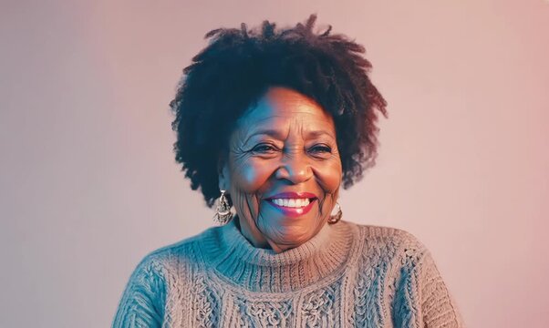 Medium shot portrait of a Nigerian woman in her 50s in a pastel or soft colors background wearing a cozy sweater